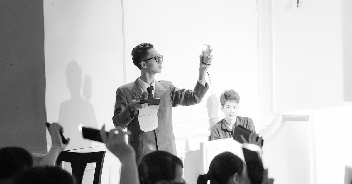 Coin dealer reviewing auction catalogs and bidding on rare coins